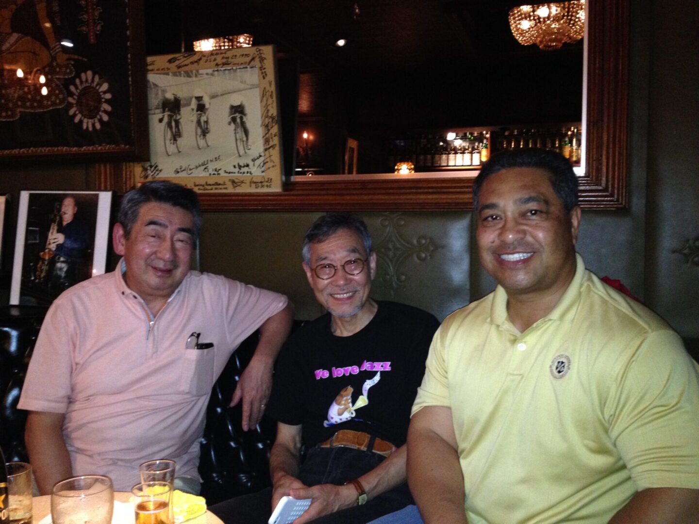 Three men sitting in a booth at a restaurant.