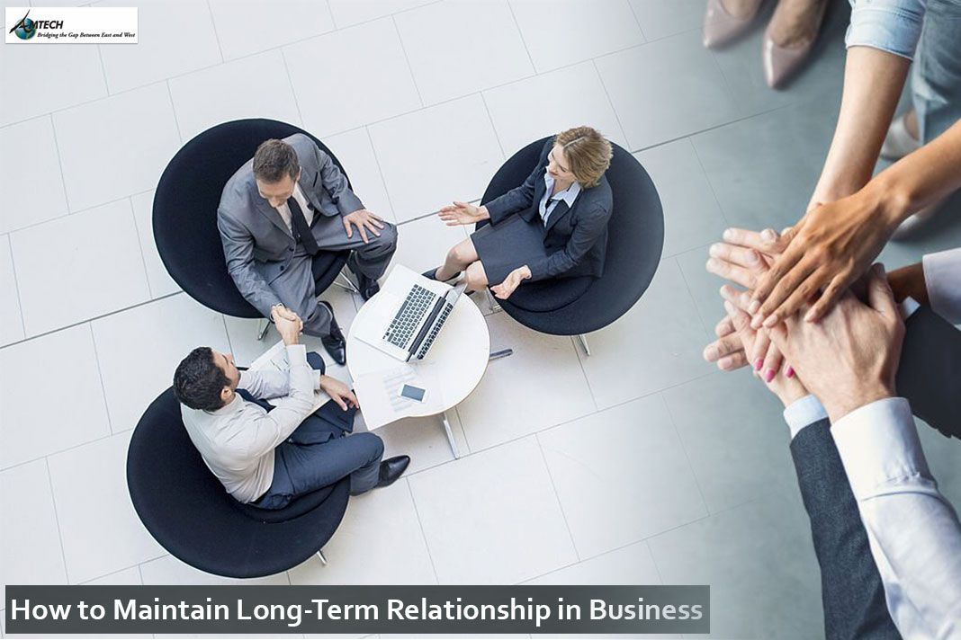 A group of people sitting around a table.