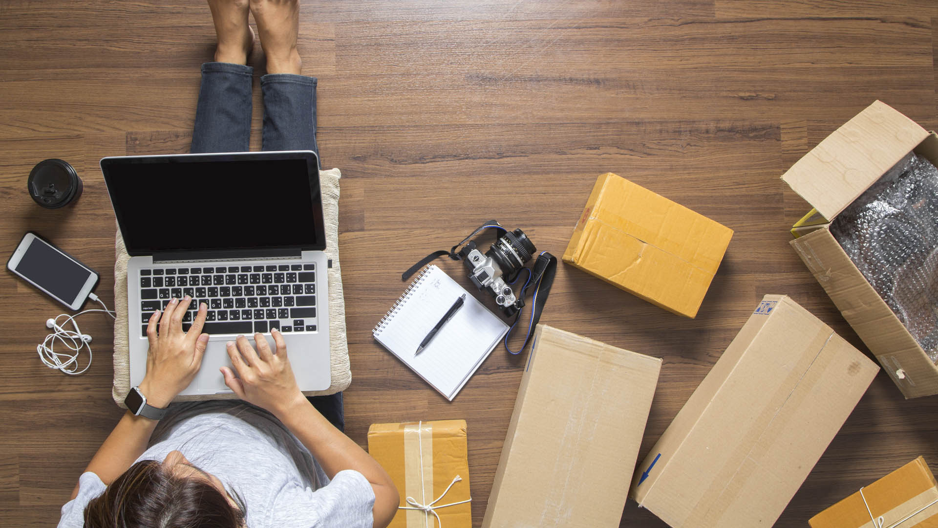 A person sitting on the floor with a laptop