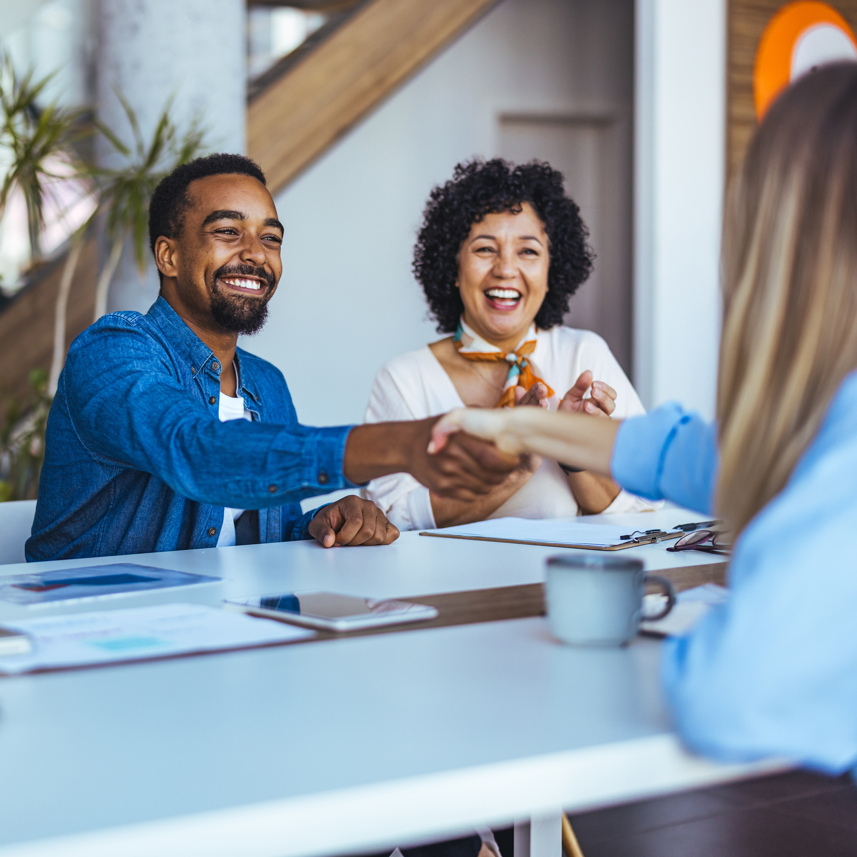 Colleagues smiling during office meeting