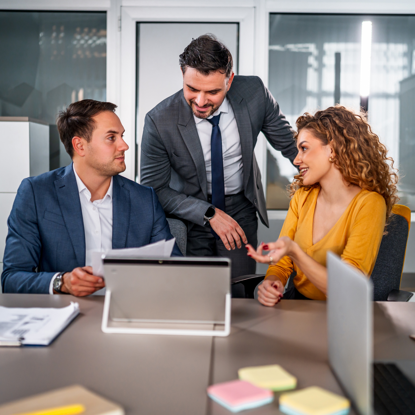 Business meeting with three colleagues discussing
