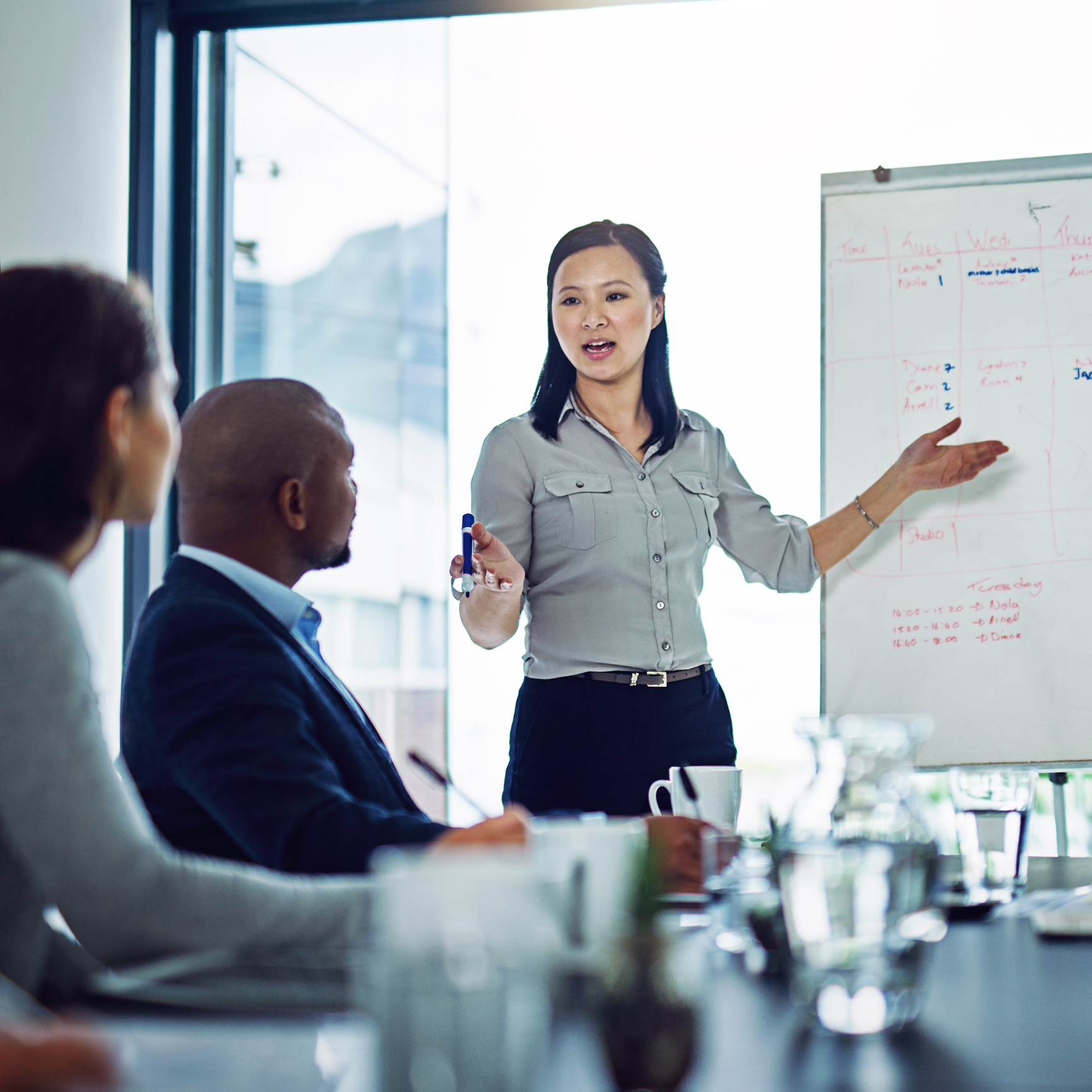 Presenter explaining strategy on whiteboard