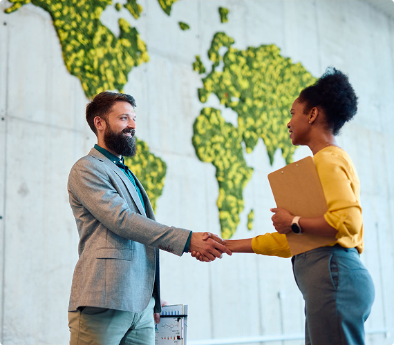 Professionals shaking hands in modern office.